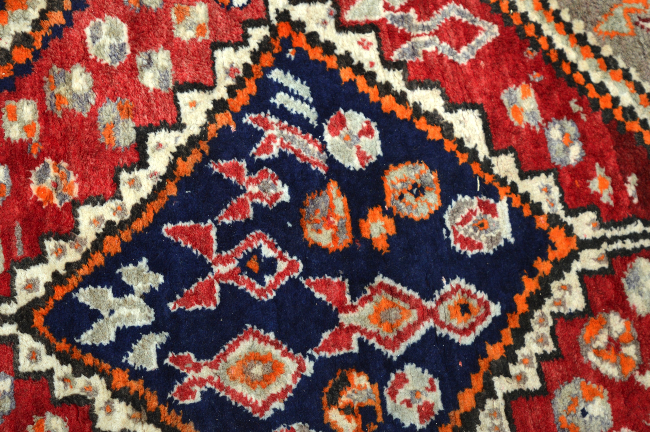 A LARGE AND UNUSUAL ORANGE GROUND CARPET decorated with central blue and red medallions. 9Ft 6ins - Image 2 of 3