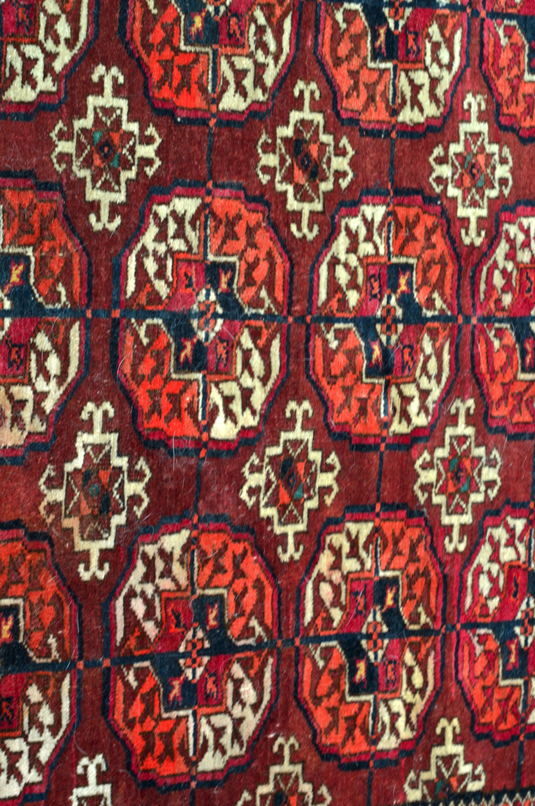 A RED GROUND PERSIAN RUG decorated with medallions within a floral border. 5Ft 10ins x 4ft 4ins. - Image 2 of 3