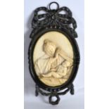 A GOOD 18TH CENTURY CONTINENTAL CARVED IVORY PANEL depicting the madonna and child, within a bronzed