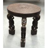 A GOOD 19TH CENTURY CEYLON CARVED WOOD OCCASIONAL TABLE with figural supports and well carved top.