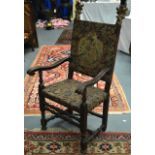 A LARGE ANTIQUE EMBROIDERED HALL CHAIR with flaming terminals. 4Ft 5ins high.