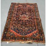 A SMALL EASTERN BLUE AND ORANGE GROUND RUG decorated with a central medallion flanked by motifs. 5Ft
