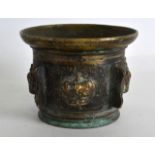 A 17TH/18TH CENTURY EUROPEAN BRONZE MORTAR decorated in relief with crown motifs. 3.75ins diameter.