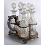 AN EARLY 19TH CENTURY ENGLISH SILVER FIVE BOTTLE CRUET STAND with stylish scrolling handle, and