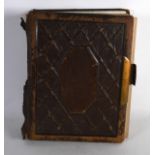 A VICTORIAN LEATHER BOUND PHOTOGRAPH ALBUMS containing various portraits, with brass lock plate.