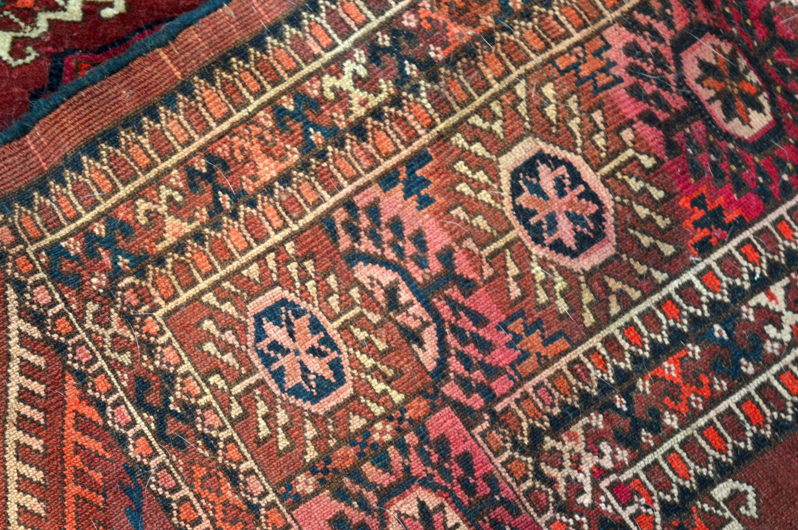 A RED GROUND PERSIAN RUG decorated with medallions within a floral border. 5Ft 10ins x 4ft 4ins. - Image 3 of 3