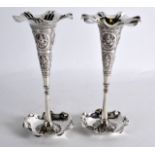 A PAIR OF LATE 19TH CENTURY INDIAN SILVER POSY VASES decorated with buddhistic motifs. 6oz. 7.5ins