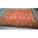 A VERY LARGE EARLY 20TH CENTURY BRITISH MADE RED GROUND CARPET decorated with various medallions and