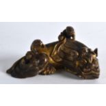 A GOOD CHINSE GILT BRONZE SCROLL WEIGHT modelled as a stylised beast, with two buddhistic pups