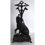 A SMALL VICTORIAN BLACK PAINTED HOUND STICK STAND. 2Ft high.