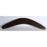 A 19TH/20TH CENTURY AUSTRALIAN CARVED WOOD BOOMERANG with textured surface. 1Ft 10ins wide.