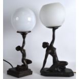 A PAIR OF ART DECO STYLE BRONZED FIGURAL TABLE LAMPS with circular white globes. 1Ft 4ins & 1ft 3ins