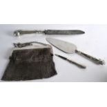 THREE SILVER HANDLED ANTIQUE UTENSILS together with a white metal purse. (4)