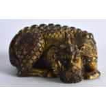 A GOOD CHINESE GILT BRONZE SCROLL WEIGHT modelled as a recumbent beast, with finely incised