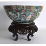 A MID 19TH CENTURY CHINESE FAMILLE VERTE BOWL painted with figures and children within interiors,