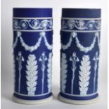 A PAIR OF 19TH CENTURY WEDGWOOD JASPERWARE CYLINDRICAL VASES decorated with classical swags and