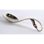 A STYLISH ARTS AND CRAFTS SILVER SPOON by Georg Jensen. 5.25ins wide.