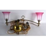 AN EDWARDIAN BRASS AND PINK GLASS TWIN HANGING LANTERN. 2Ft wide.