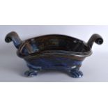 A STYLISH AND UNUSUAL VINTAGE TWIN HANDLED STUDIO POTTERY BOWL with high raised scrolling handle.