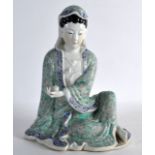 AN EARLY 20TH CENTURY CHINESE FAMILLE ROSE FIGURE OF GUANYIN modelled holding a fruit, upon a