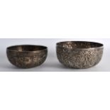 A 19TH CENTURY INDIAN WHITE METAL EMBOSSED BOWL together with another smaller bowl. 298 grams. 4.