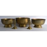 A GROUP OF THREE 19TH CENTURY EASTERN BRASS BOWLS together with a pair of European pricket