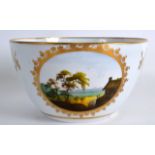 AN EARLY 19TH CENTURY MINTON BOWL painted with a landscape pattern 52. 6ins diameter.