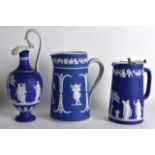 A 19TH CENTURY WEDGWOOD JASPERWARE CLASSICAL JUG together with two other jugs, decorated with