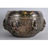 A 19TH CENTURY INDIAN EMBOSSED WHITE METAL BOWL decorated with buddhistic figures beside scrolling