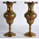 A PAIR OF INDIAN ENAMELLED BRASS VASES decorated with foliage. 7.25ins high.