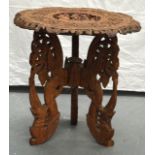 AN EARLY 20TH CENTURY SOUTH EAST ASIAN CARVED WOOD TABLE decorated with figures. 2Ft 1ins diameter.