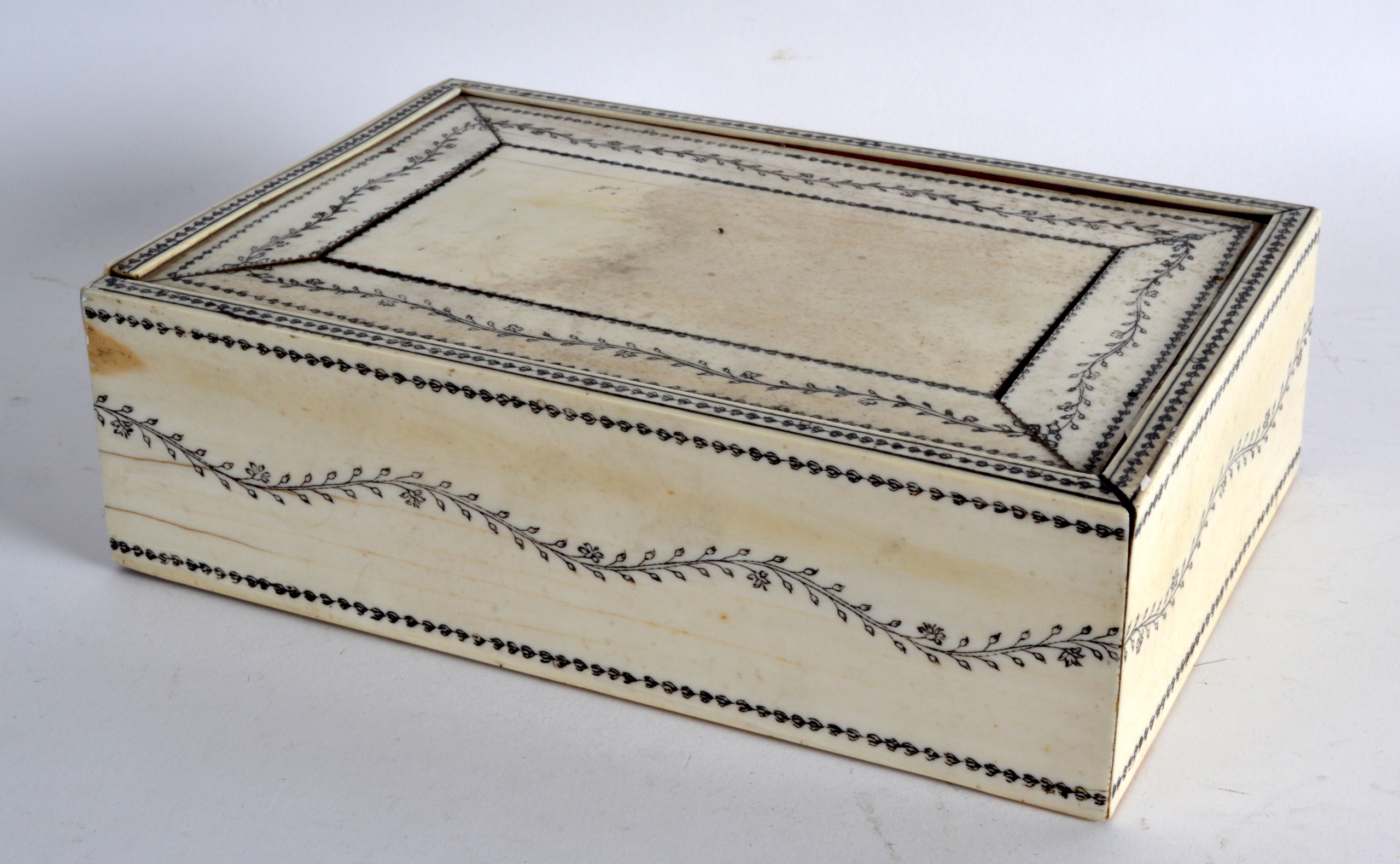 A MID 19TH CENTURY ANGLO INDIAN IVORY RECTANGULAR BOX AND COVER engraved with scrolling foliage