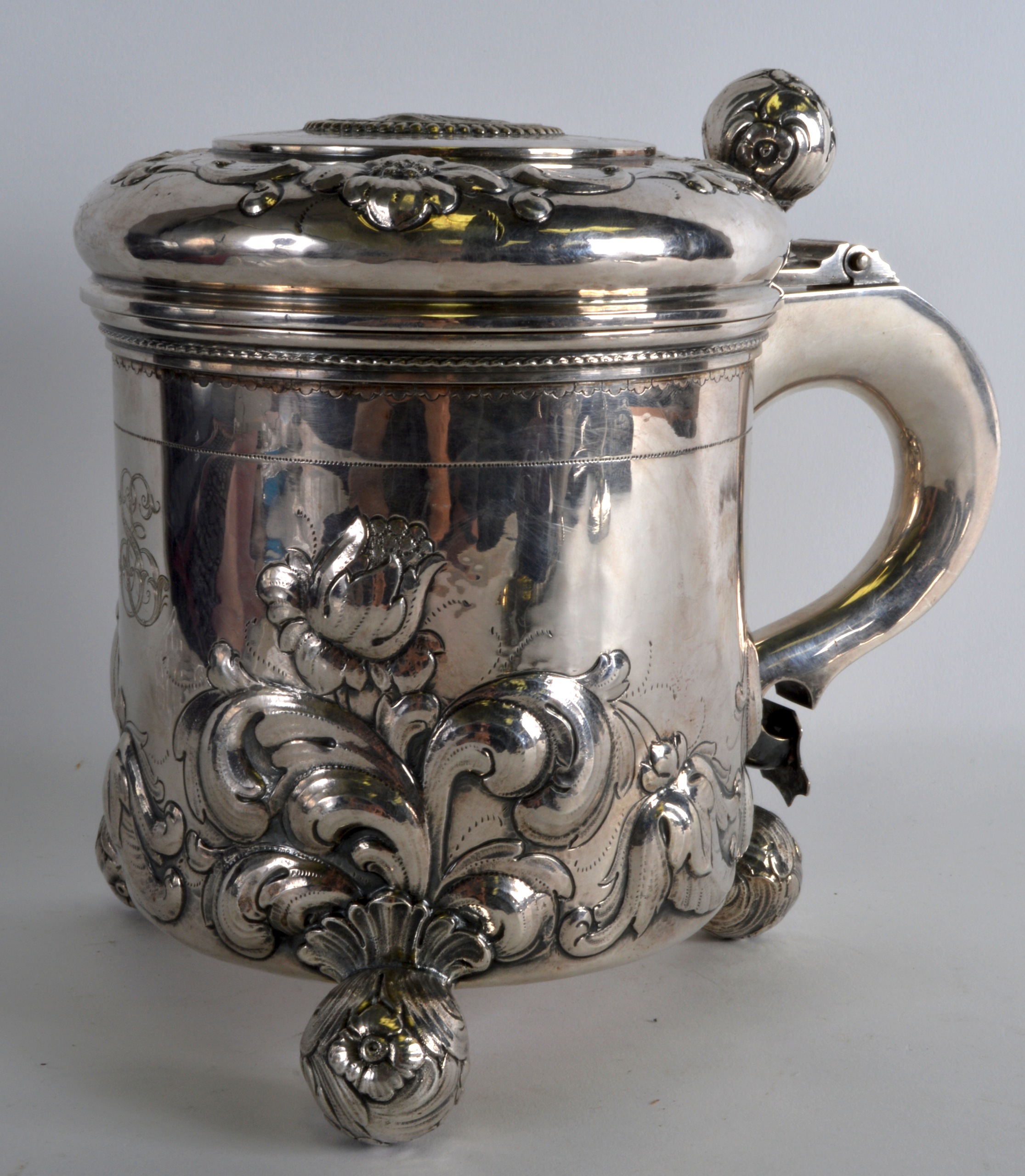 A LATE 18TH CENTURY SCANDANAVIAN SILVER PEG TANKARD the top inset with a coin, decorated in relief