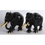 A PAIR OF EARLY 20TH CENTURY AFRICAN CARVED EBONY AND IVORY ELEPHANTS C1910 modelled in a roaming