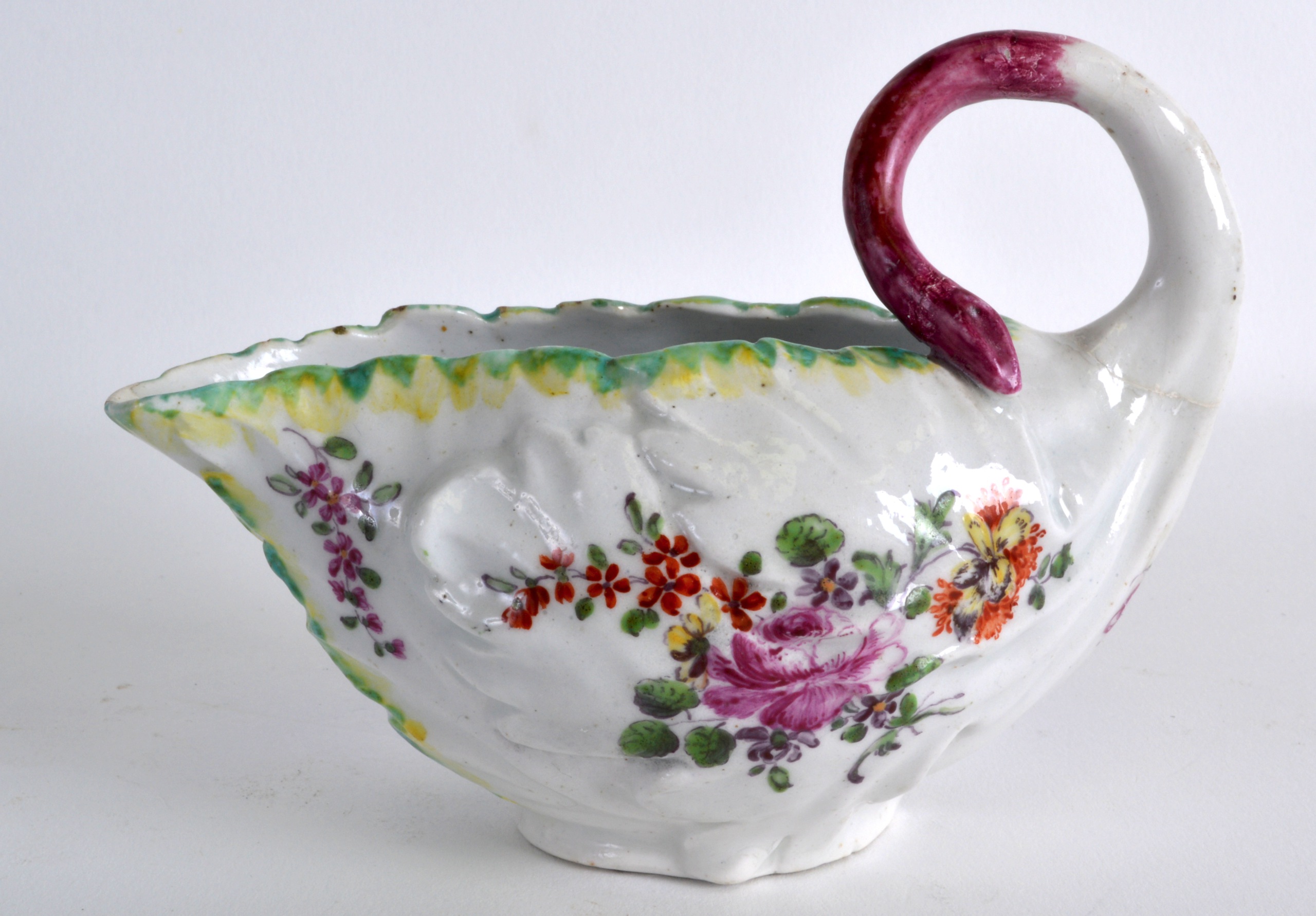 AN 18TH CENTURY DERBY COS LETTUCE LEAF SAUCEBOAT moulded and painted with flowers. 5.25ins wide.