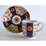 AN 18TH CENTURY WORCESTER COFFEE CUP AND SAUCER painted with a version of the Old Japan Star