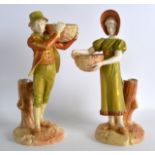 A PAIR OF ROYAL WORCESTER KATE GREENAWAY STYLE FIGURES OF A BOY AND GIRL modelled holding baskets.