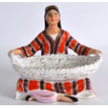 A USSR FIGURE OF A GIRL HOLDING A BASKET. 4.75ins high.