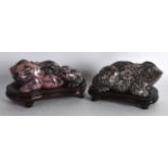 AN UNUSUAL PAIR OF EARLY 20TH CENTURY CHINESE CARVED HARDSTONE TOADS with lovely natural inclusions.