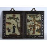 A PAIR OF EARLY 20TH CENTURY CHINESE HARDSTONE PANELS contained within pierced foliage frames,