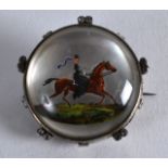 A GOOD 19TH CENTURY SILVER MOUNTED REVERSE PAINTED CRYSTAL BROOCH decorated with a female on