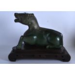 A GOOD CHINESE QING DYNASTY CARVED JADE FIGURE OF A BUFFALO boldly modelled and recumabant in