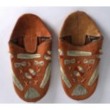 AN UNUSUAL PAIR OF NORTH AMERICAN MI'KMAQ MOCCAINS embroidered with motifs. 9.75ins long.