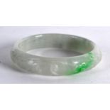 A CHINESE CARVED JADEITE CIRCULAR BANGLE decorated with birds and foliage. 2.75ins diameter.