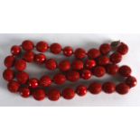 A CHINESE CARVED CINNABAR LACQUER NECKLACE of spherical form, with central red lacquer beads. 2Ft