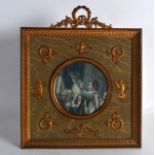 A 19TH CENTURY FRENCH GILT METAL EMPIRE PHOTOGRAPH FRAME inset with a ceremonial image, the frame