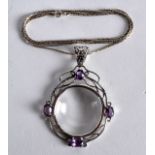 A SILVER AND AMETHYST SET SPY GLASS ON CHAIN.