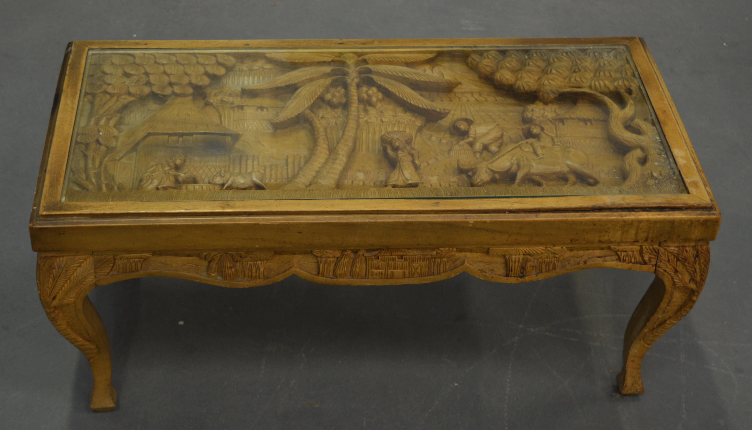 A CARVED HARDWOOD COFFEE TABLE. 3 ft wide.