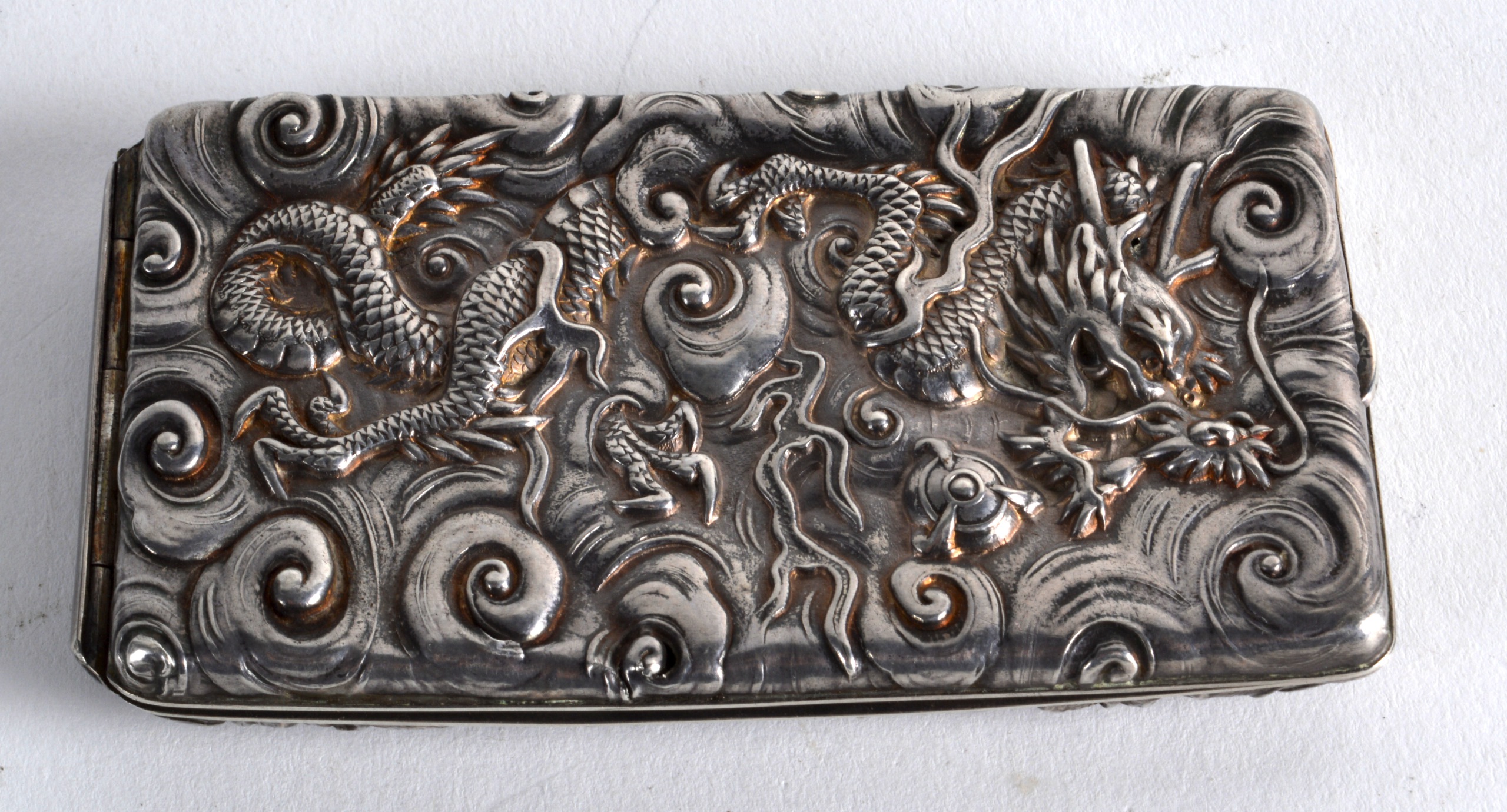AN UNUSUAL LATE 19TH CENTURY JAPANESE MEIJI PERIOD SILVER CASE decorated in relief with dragons