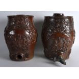 A PAIR OF 19TH CENTURY ENGLISH STONEWARE BRANDY CASKS decorated in relief with grape vines and a